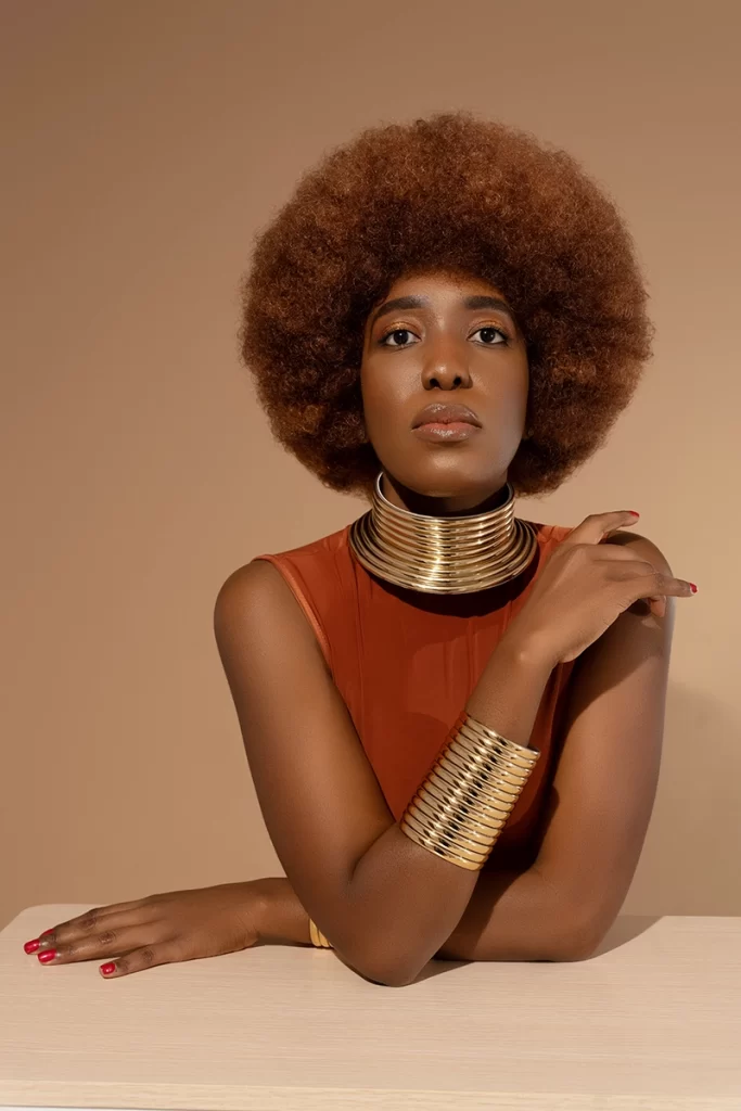 african-american-woman-posing-with-traditional-gold-bracelets-and-necklace