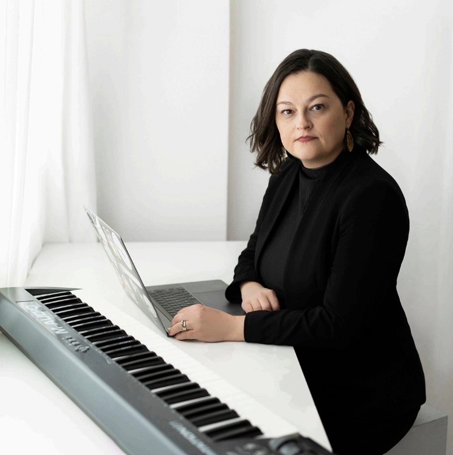 Composer with her keyboard and laptop