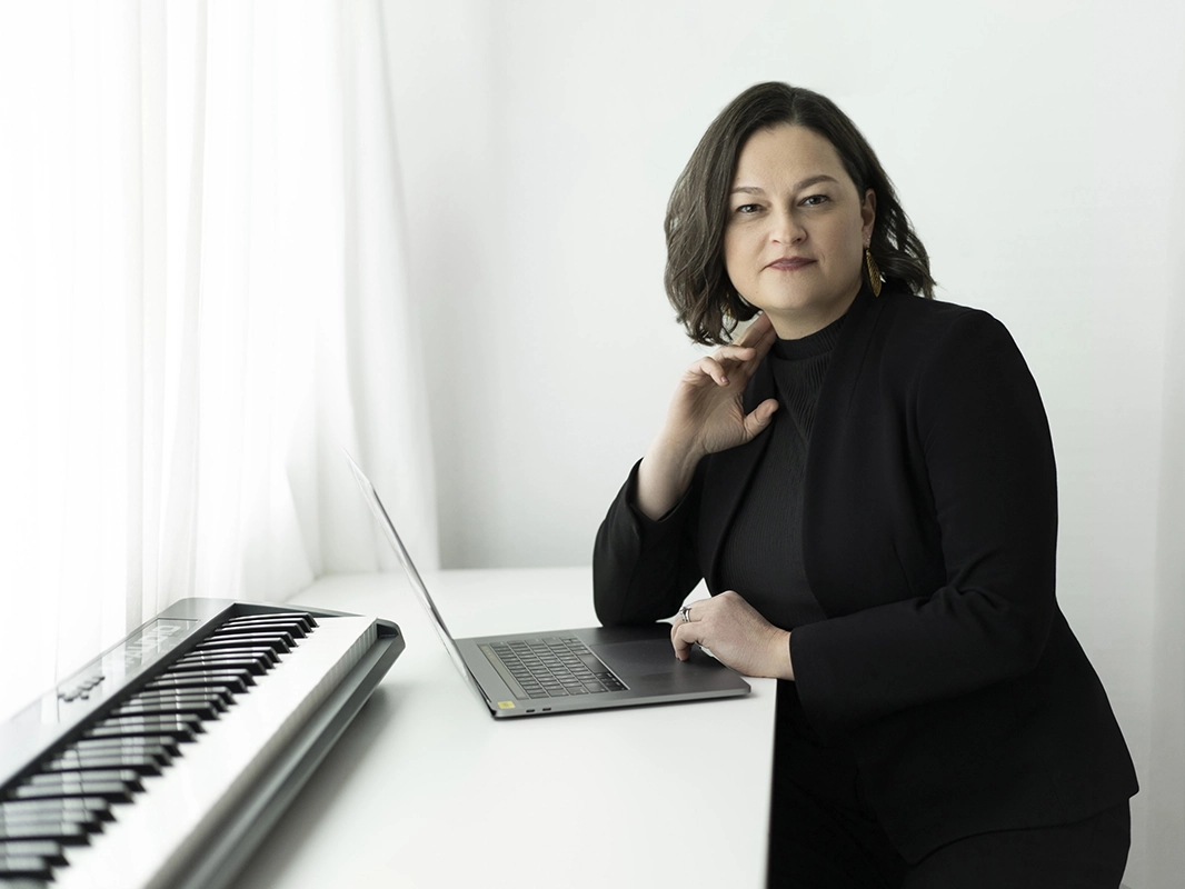 composer-posing-next-to-her-keyboard-and-laptop