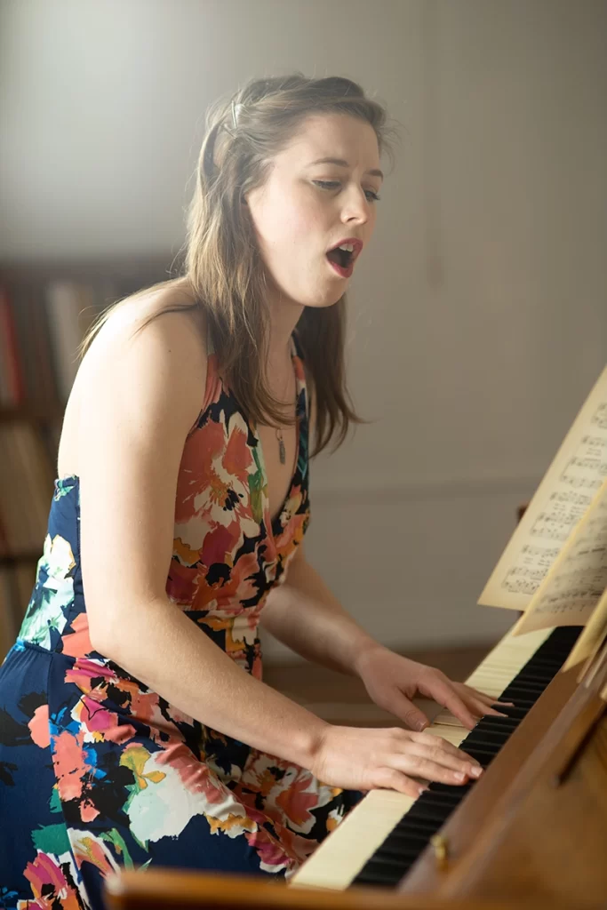 woman-playing-piano-and-singing