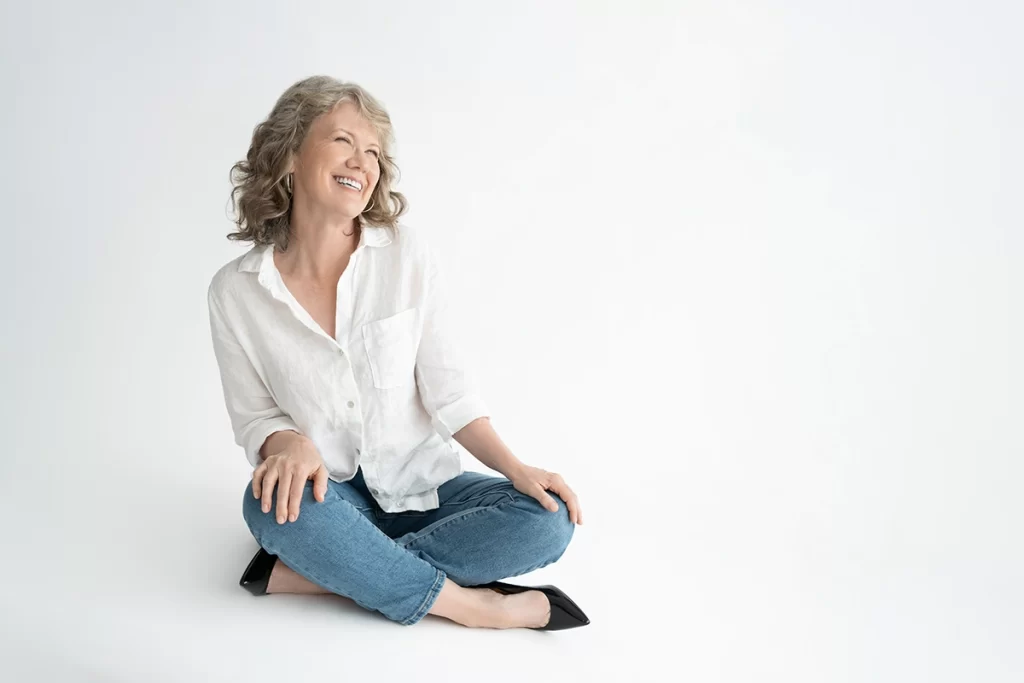 woman-sitting-criss-cross-applesauce-smiling