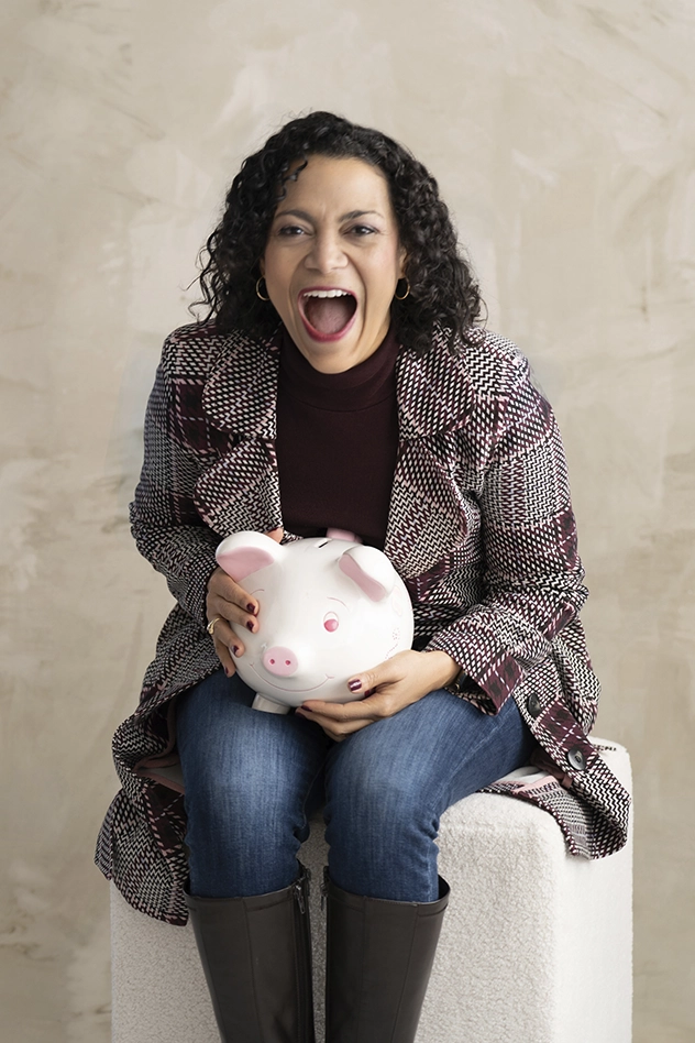 woman-sitting-down-and-holding-piggy-bank-really-excited