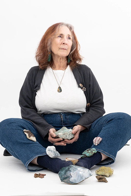 woman-sitting-down-with-different-crystals-all-around-her