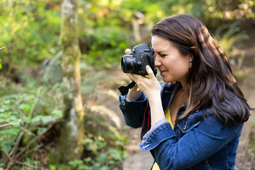 woman-taking-photos-with-camera-in-nature