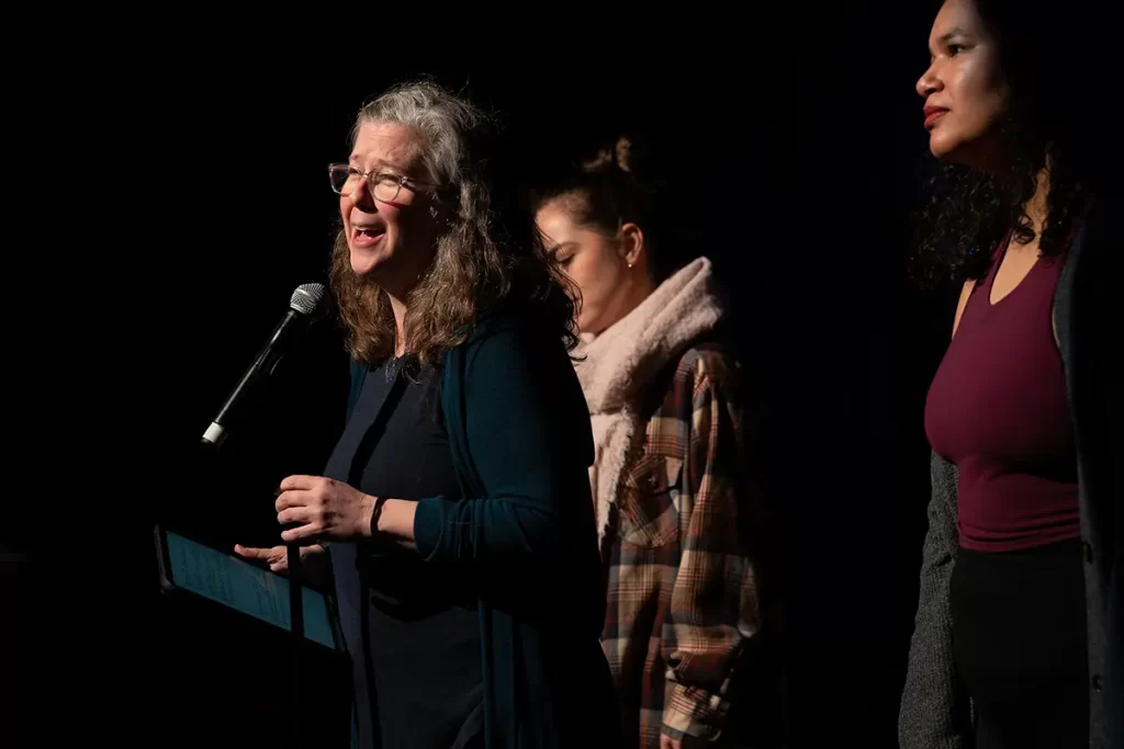 photograph of a woman speaking on stage | zing studio sherwood